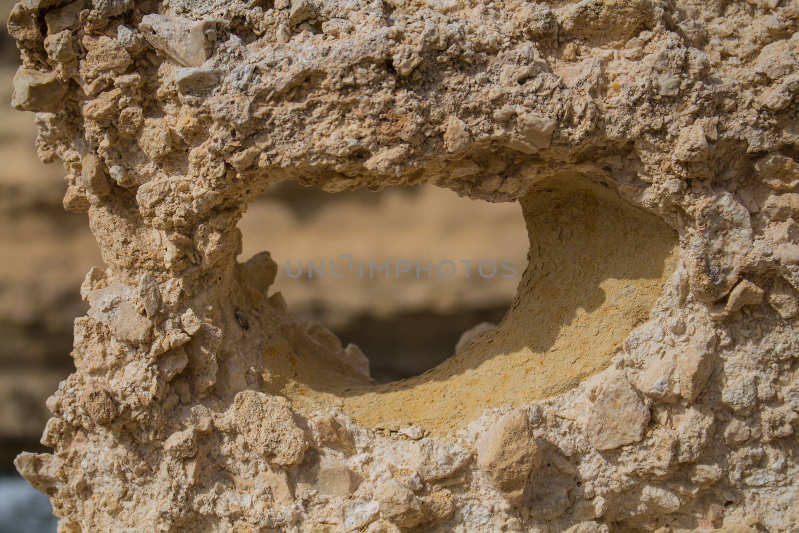 Part of a rock on the seaside, where the waves and wind created a hole.