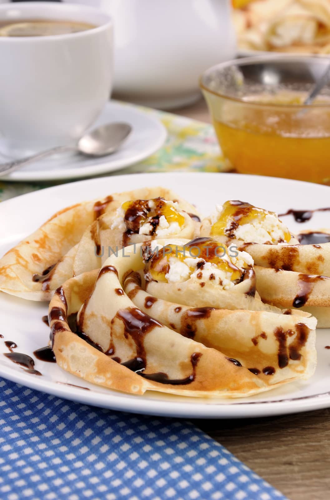 Pancake folded in the form of a snail cottage cheese with chocolate