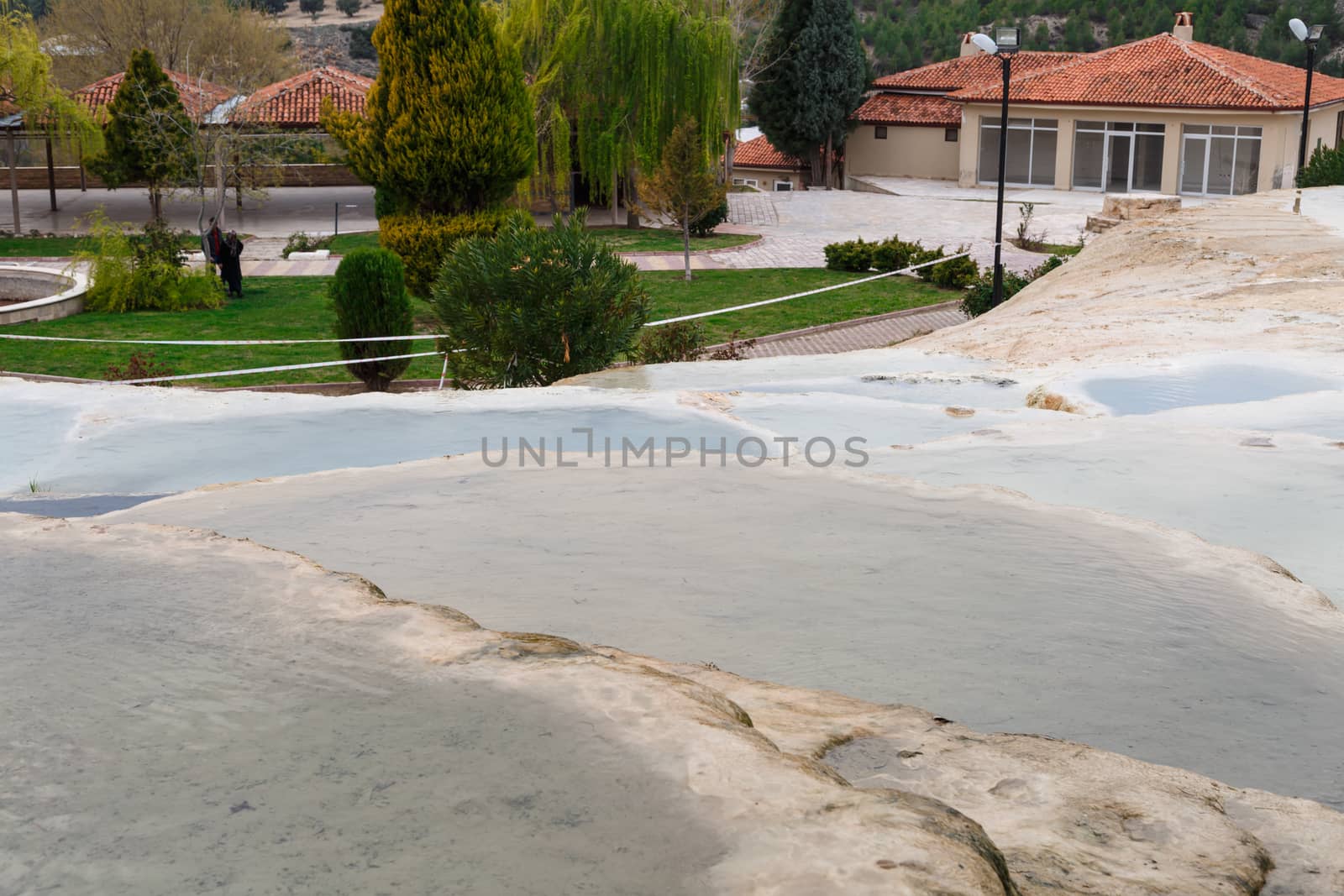 View of natural geographical formations in Pamukkale area in Turkey with travertine pools.