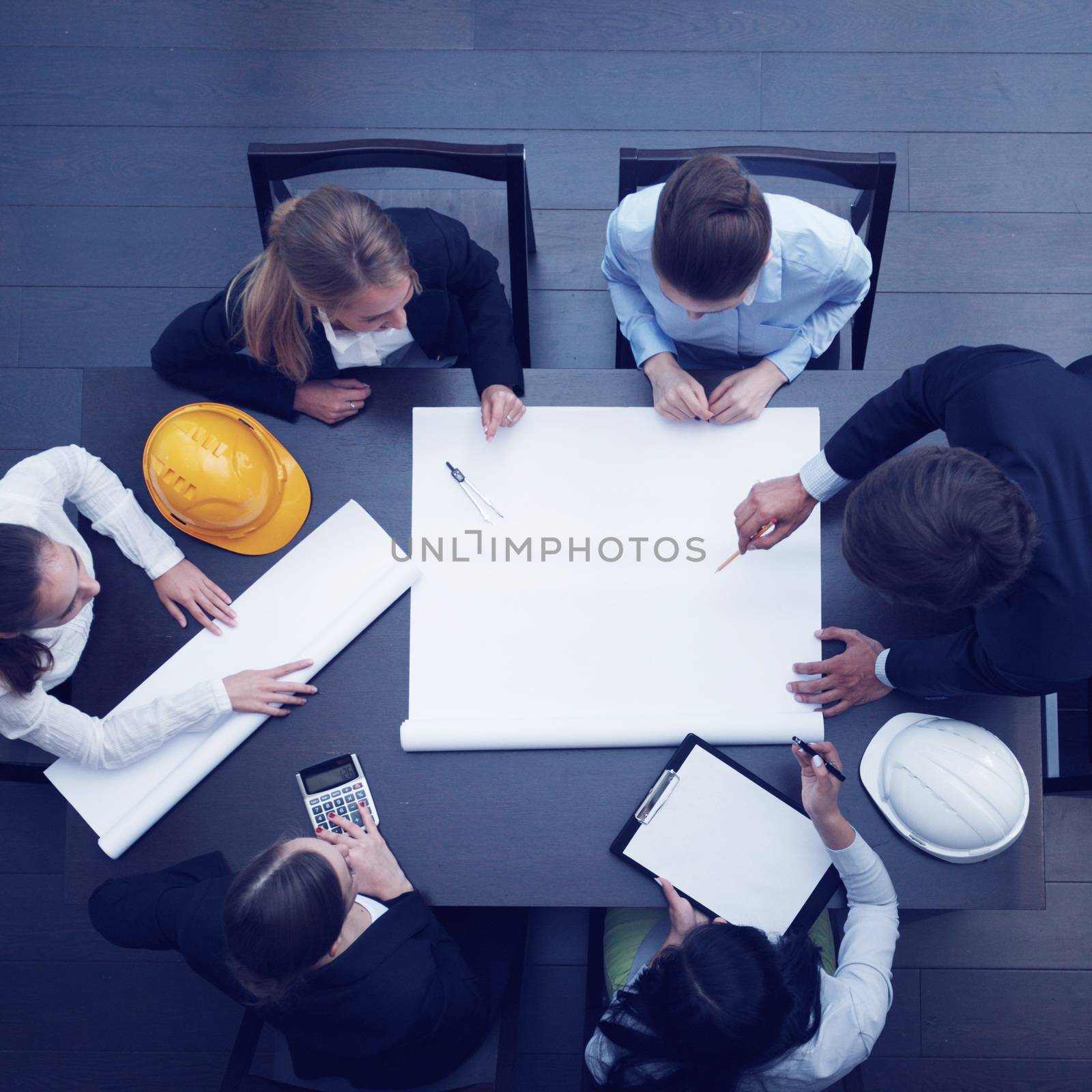 Top view of people around table in construction business meeting