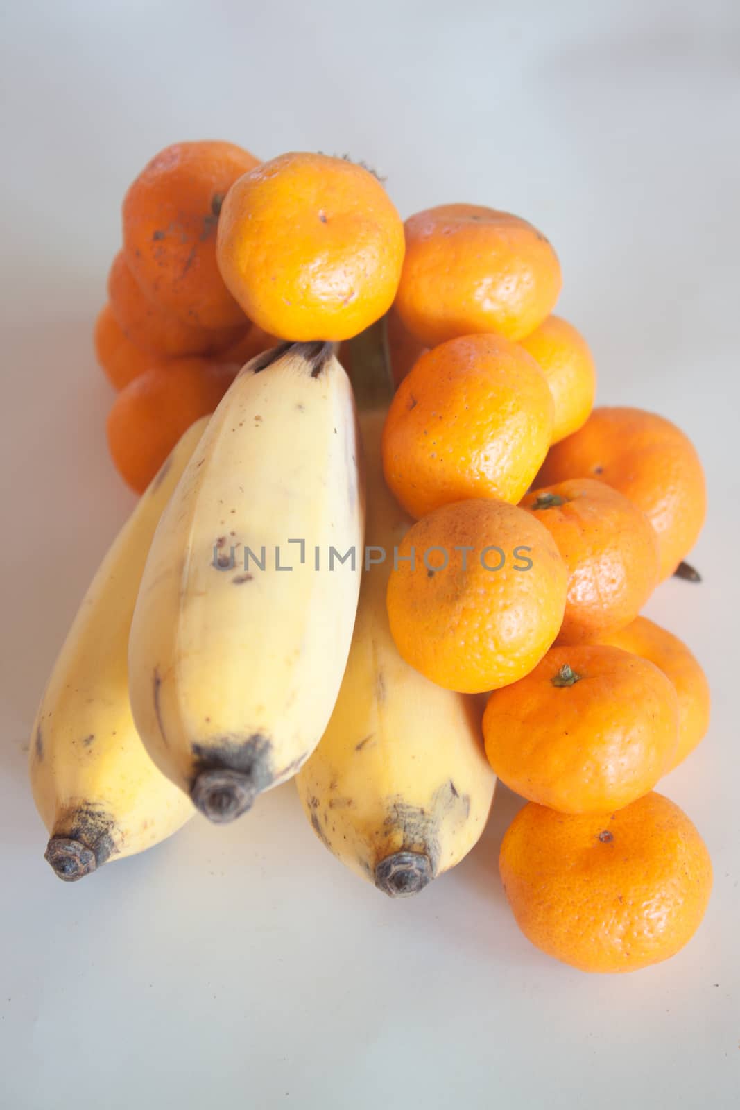 fresh orange and banana isolated on a white background