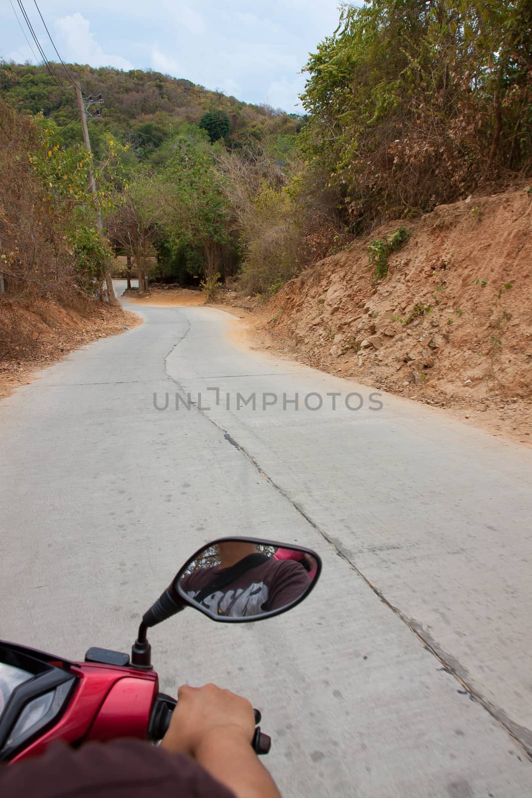 Driving a motorcycle down the mountain.