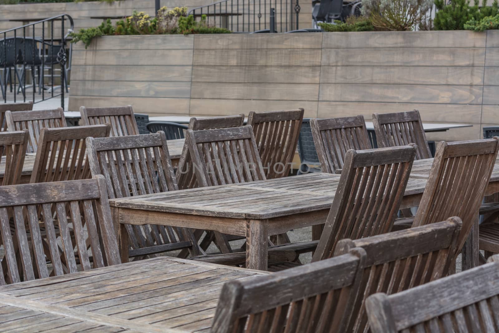 Beer garden wooden tables on the terrace of a restaurant.