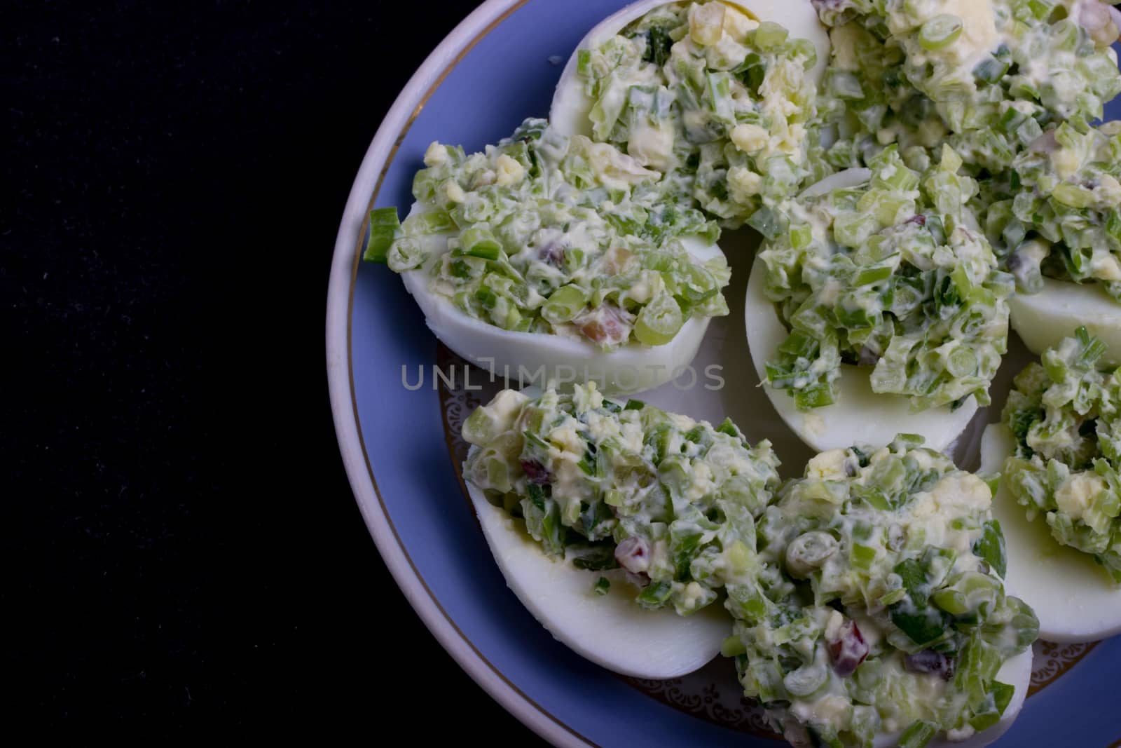 salad with egg and mayonnaise on a plate with a blue border