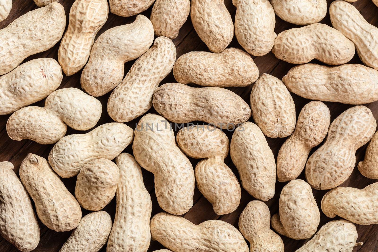 groundnut in the skin close-up on a wooden background