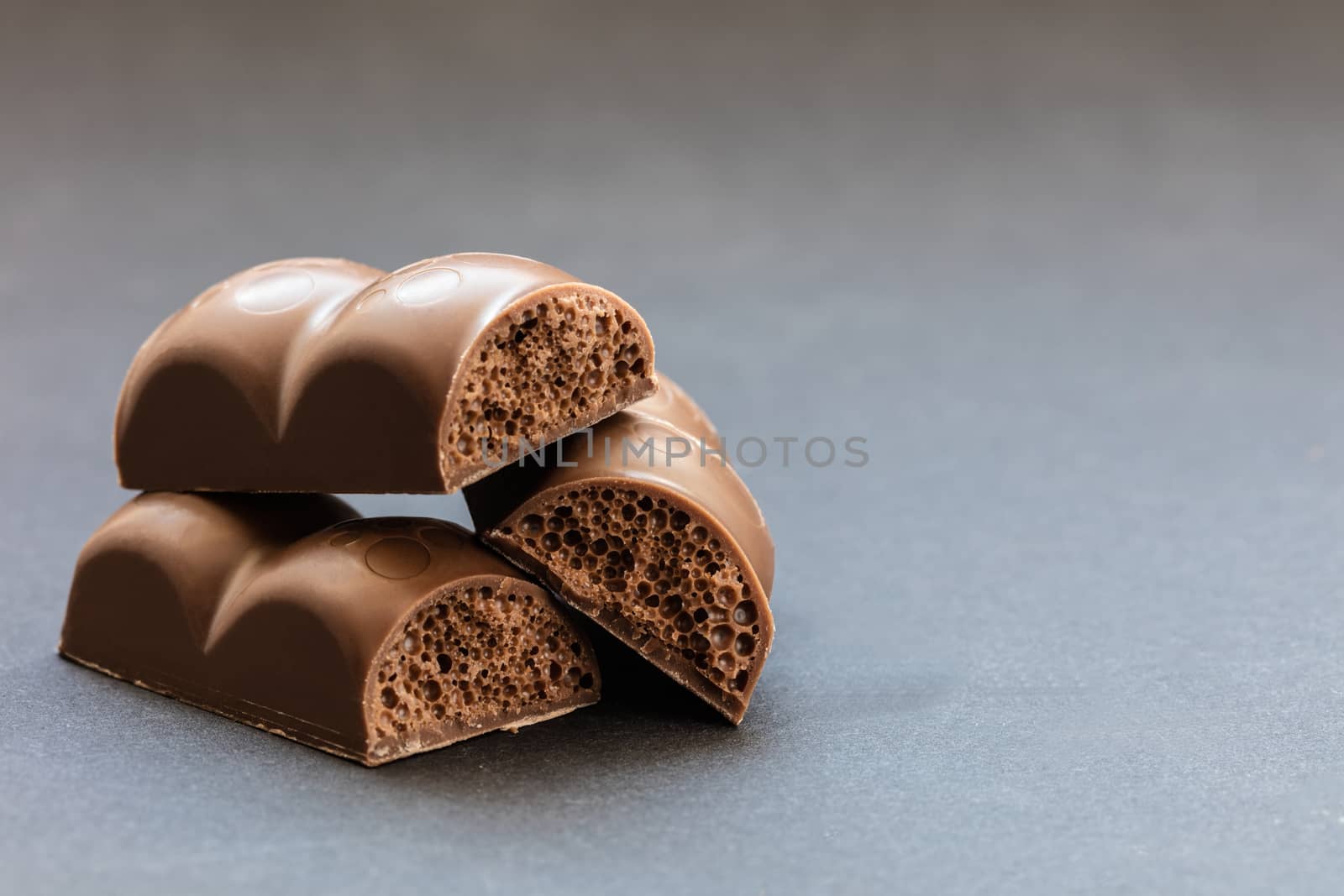 part porous chocolate close-up on a dark background