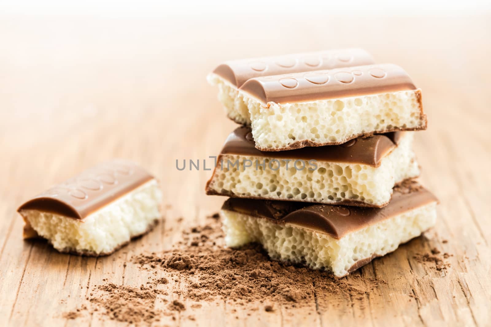 part porous chocolate close-up on a wooden background