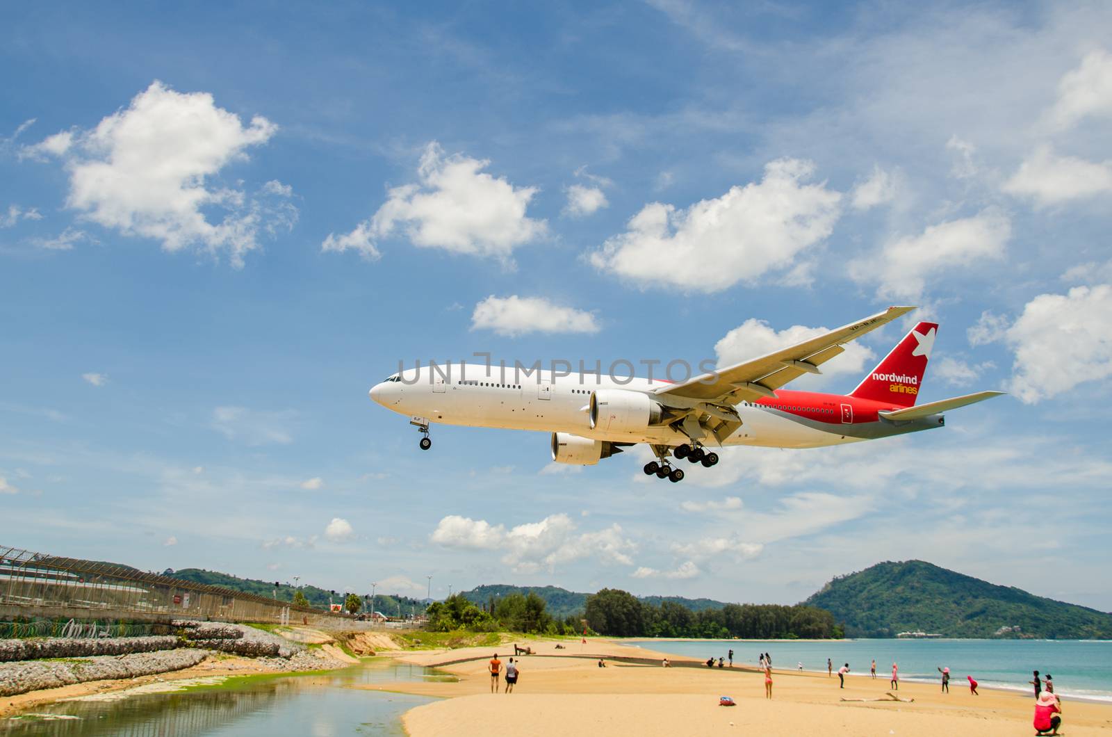 PHUKET - MAY 5 : Nordwind airlines airplane landing at Phuket International airport, runway near the beach, on May 5, 2016 Phuket, Thailand.