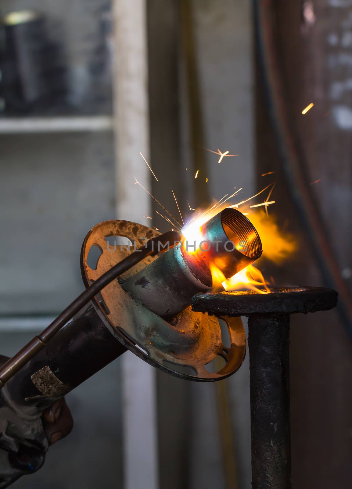 Welders were repairing cutting Shock absorbers of a car in workshop