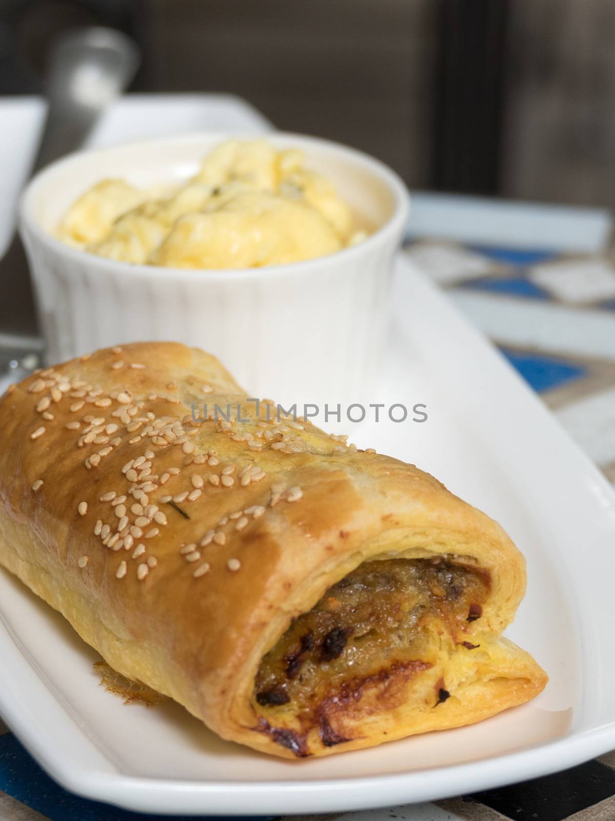 Close up of sausage roll in white plate