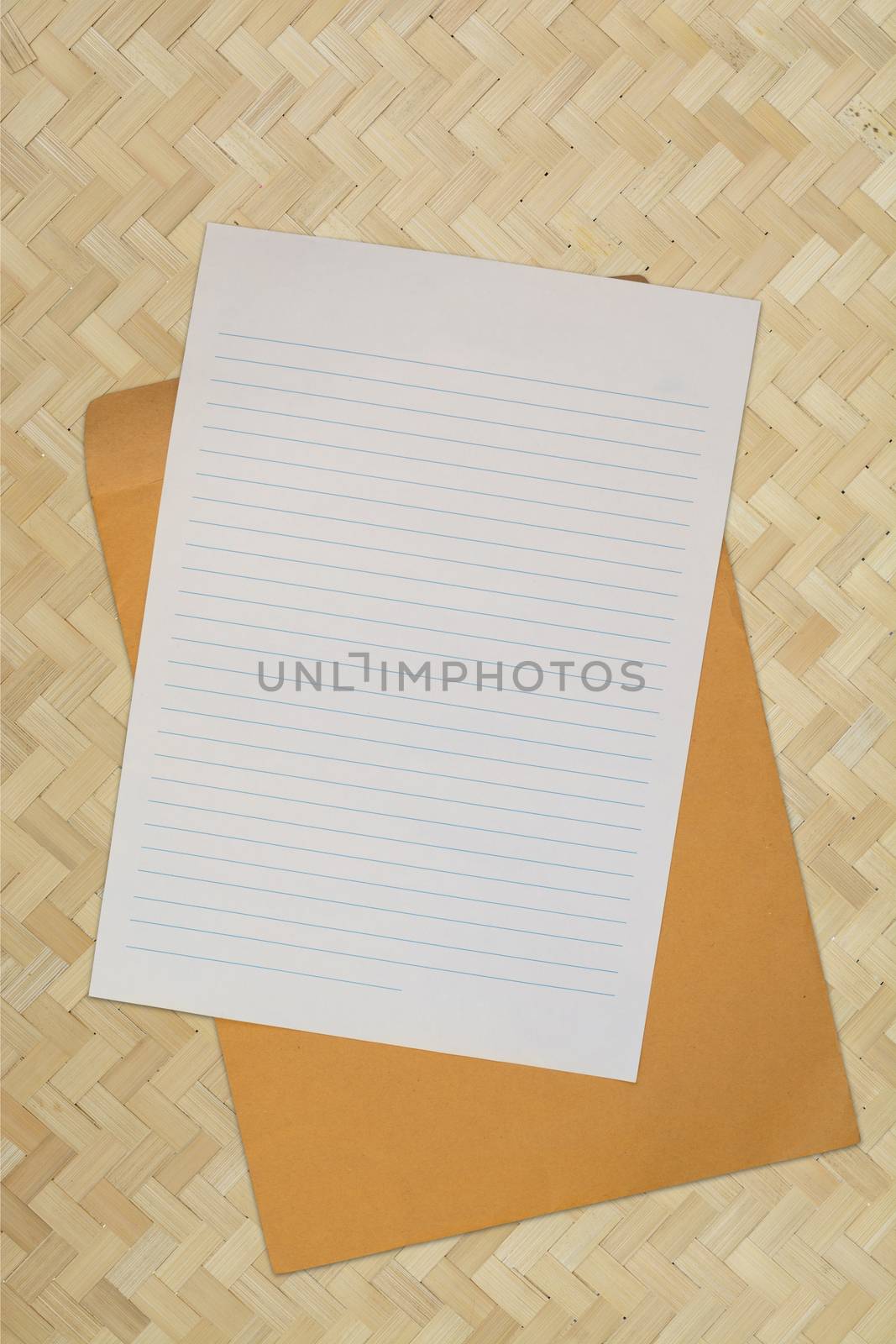 Blank Line paper with Envelope over Bamboo Weaving Background by thampapon