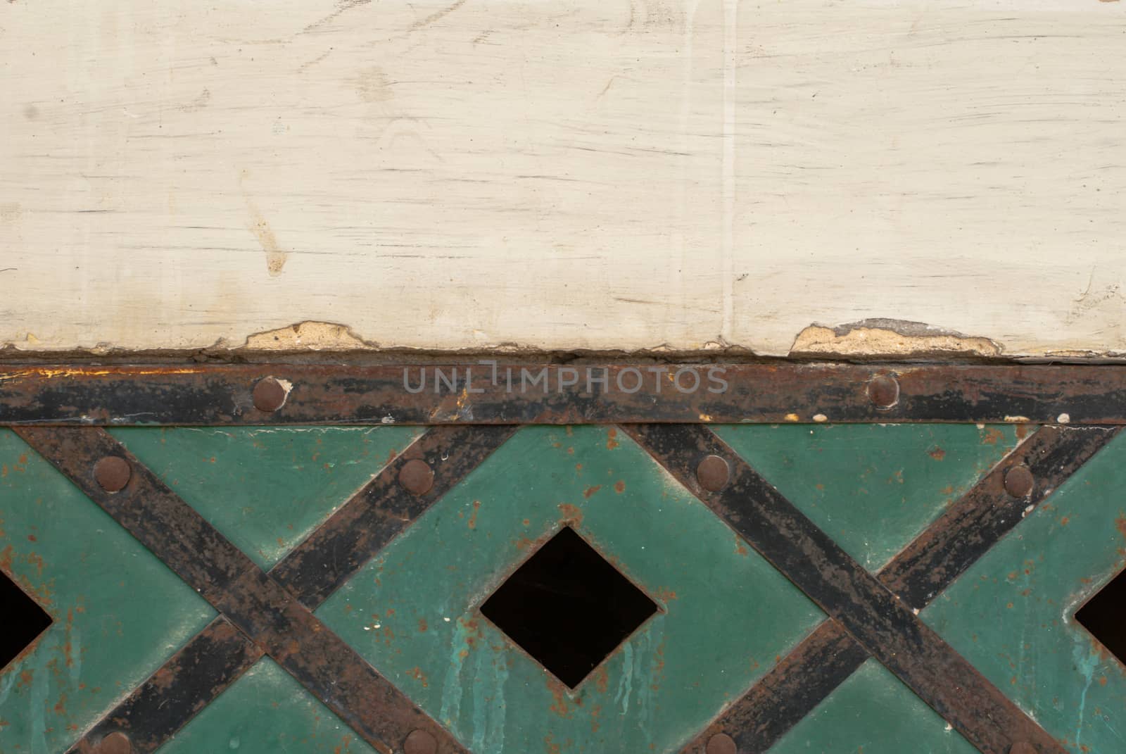 fragment of an iron surface is covered with green color paint, which has long been under the influence of different climatic conditions