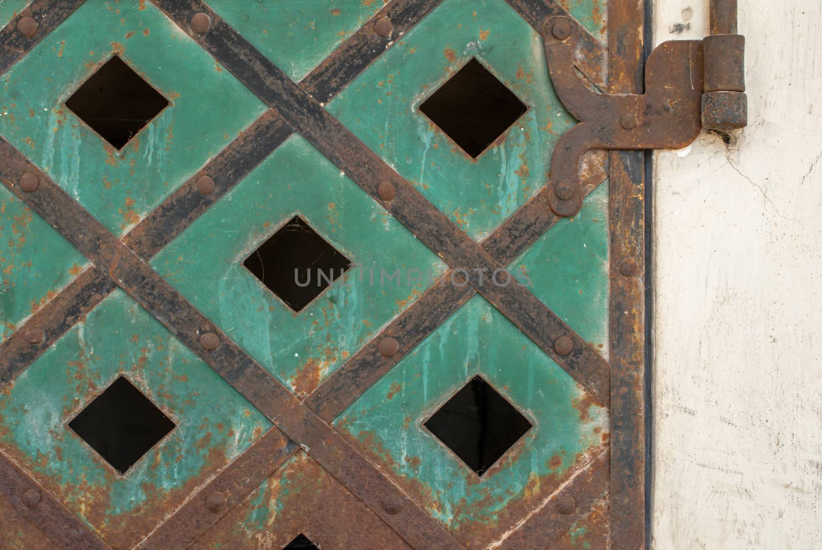 fragment of an iron surface is covered with green color paint, which has long been under the influence of different climatic conditions