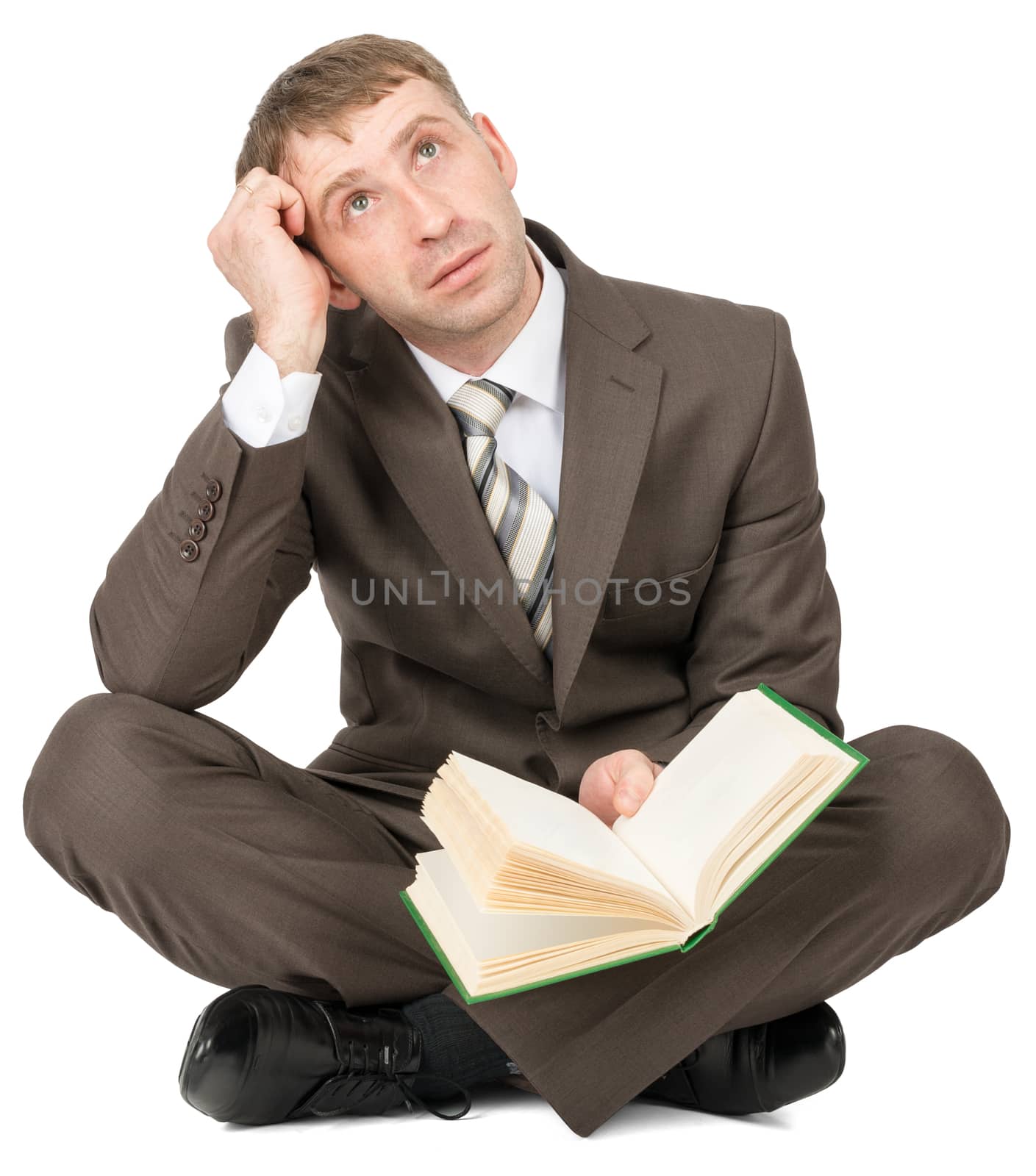 Businessman sitting with book and thinking by cherezoff