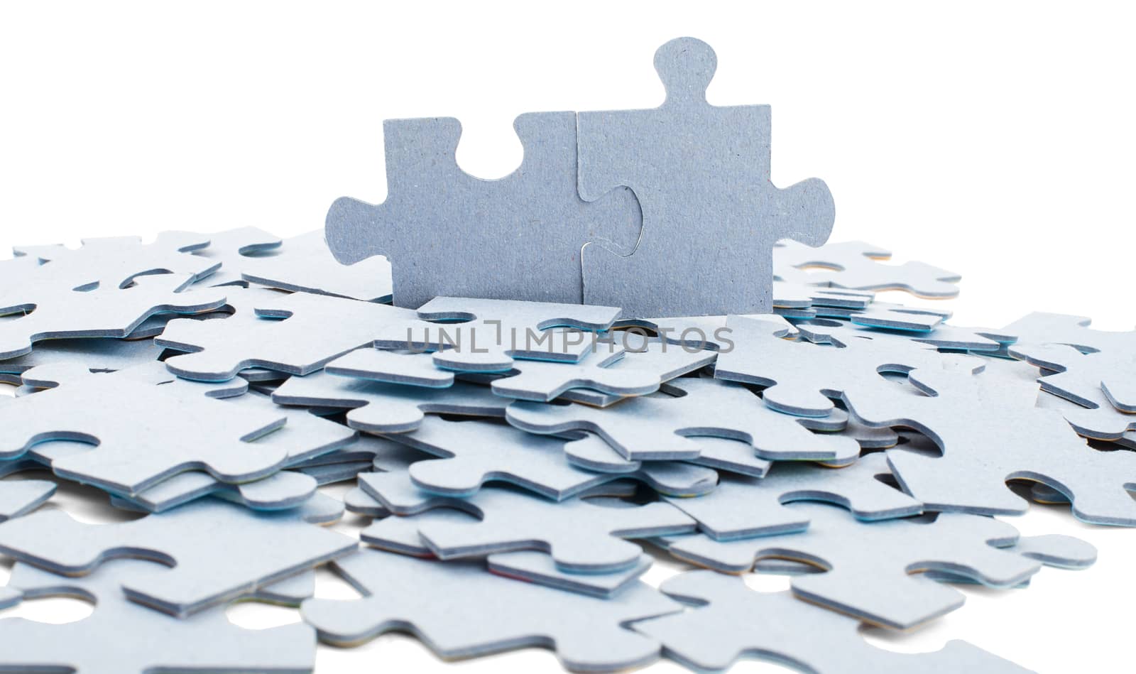 Scattered wooden puzzle pieces isolated on white background