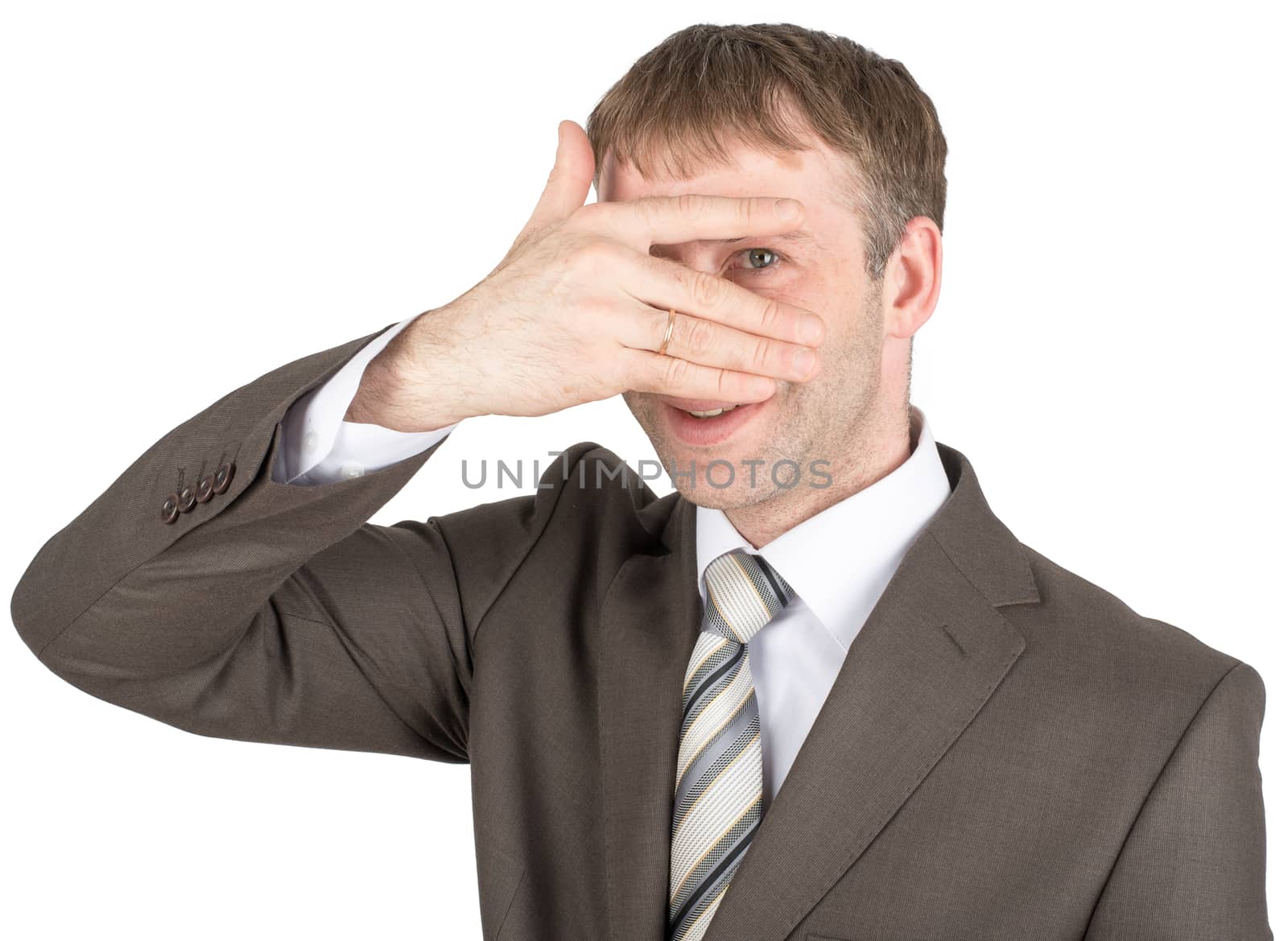 Surprised young man hiding eyes behind his hand isolated on white background