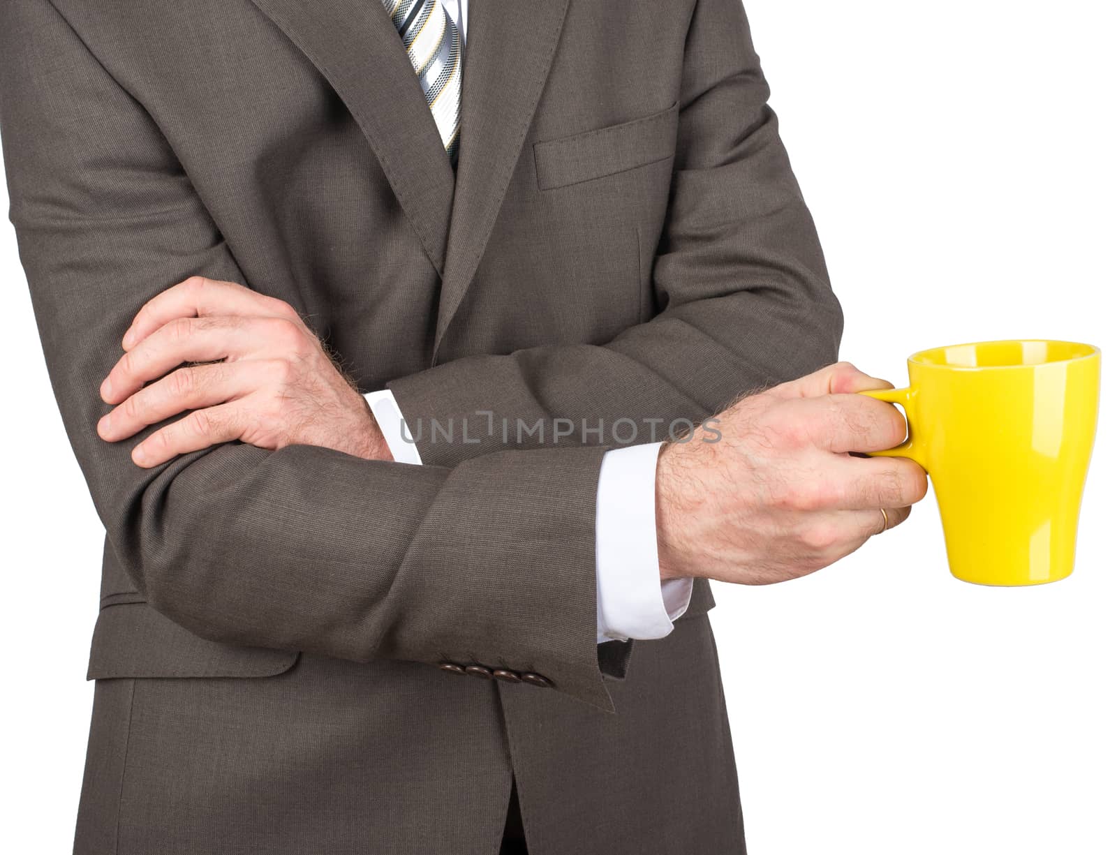 Businessman holding yellow cup of coffee by cherezoff