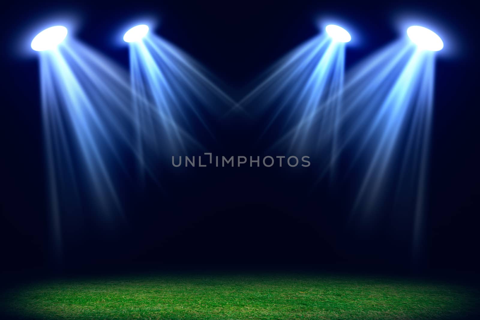 Grass field lit with bright spotlights. Abstract background for your product