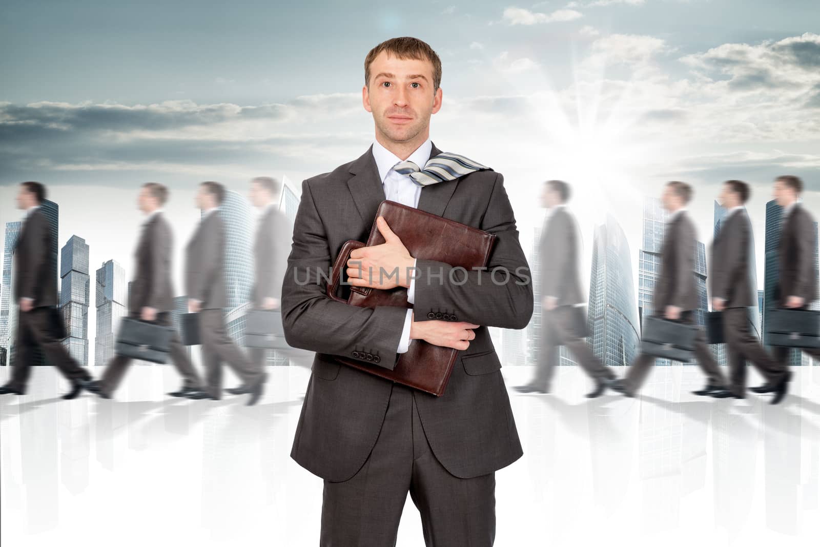 Businessman holding briefcase. Many people walking on background