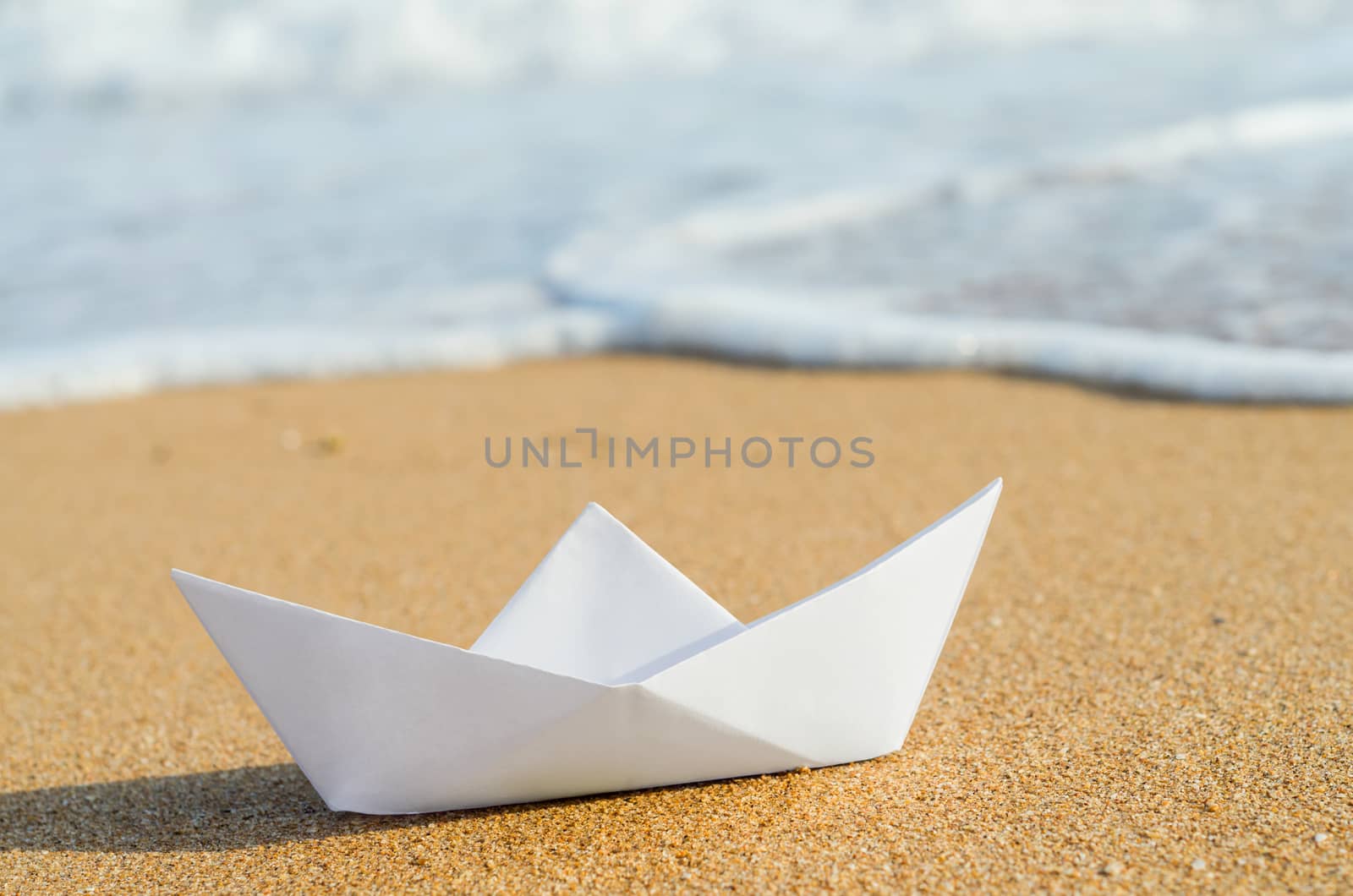 white paper boat on beach, summer holiday