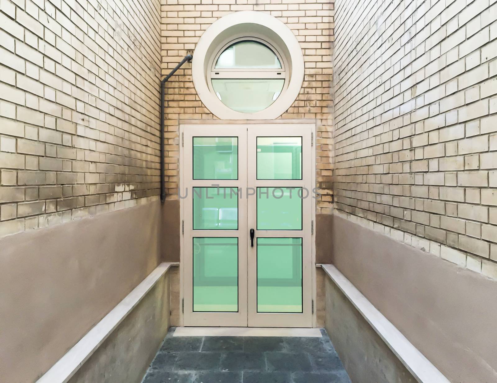 closed windows door with bricked walls