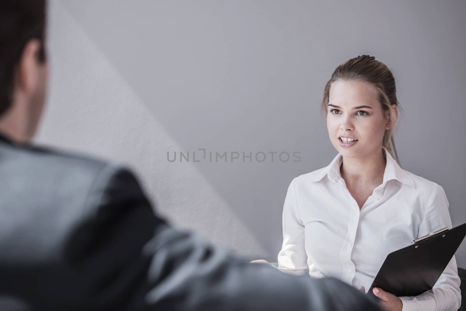 Business woman interviewing business man in modern office 