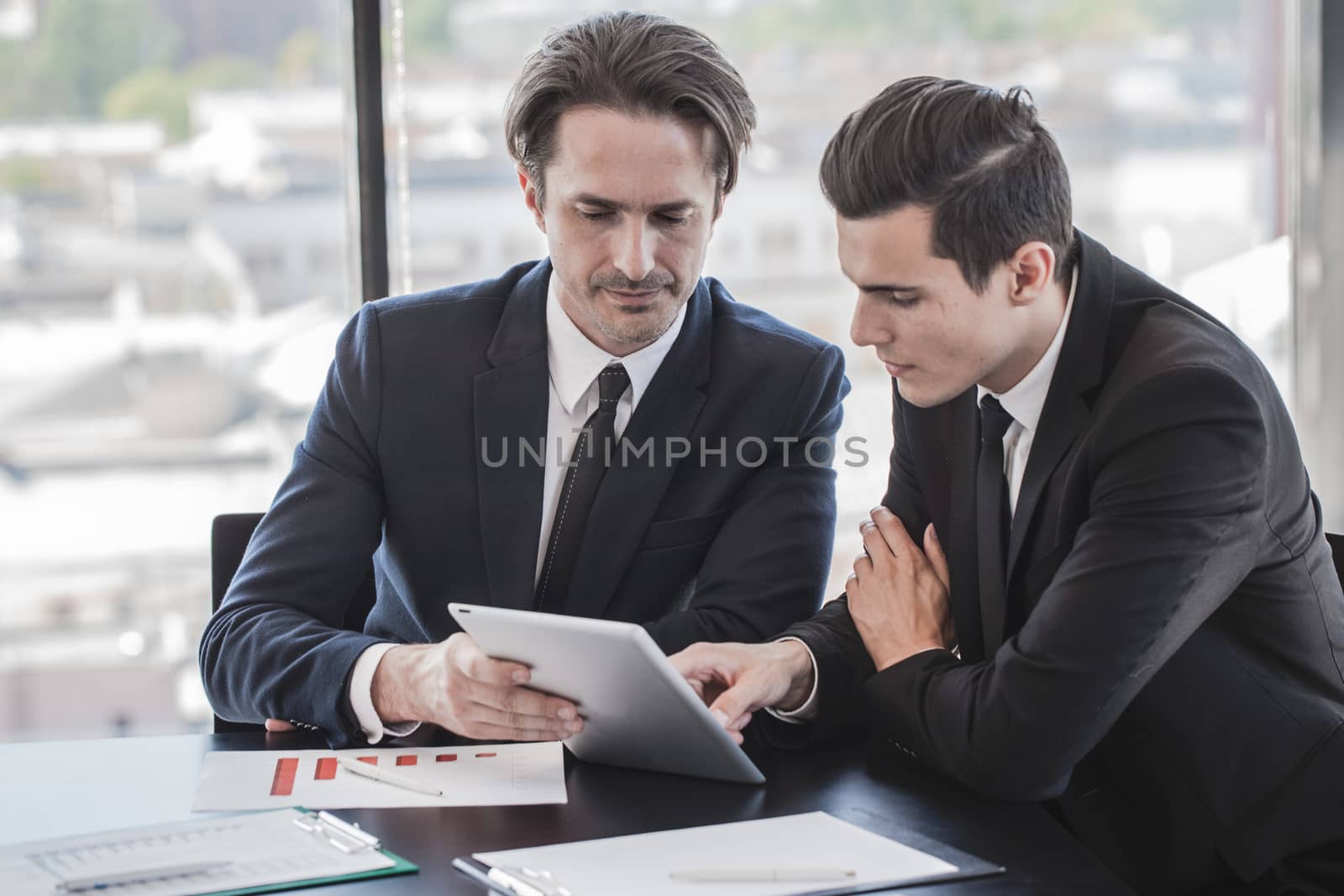 Business people discussing charts  by ALotOfPeople