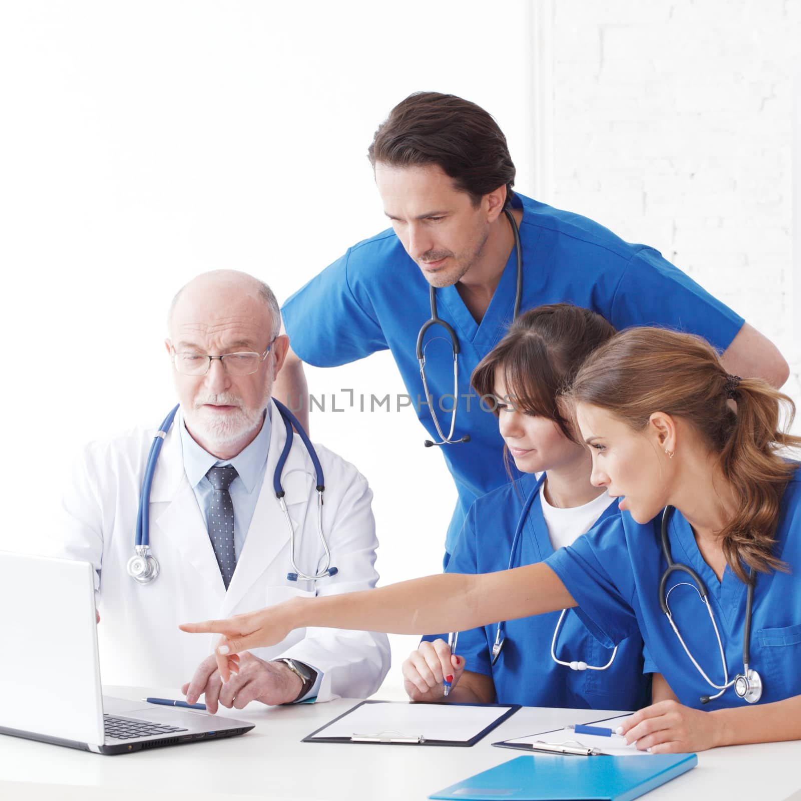 Medical doctors team using computer isolated on white
