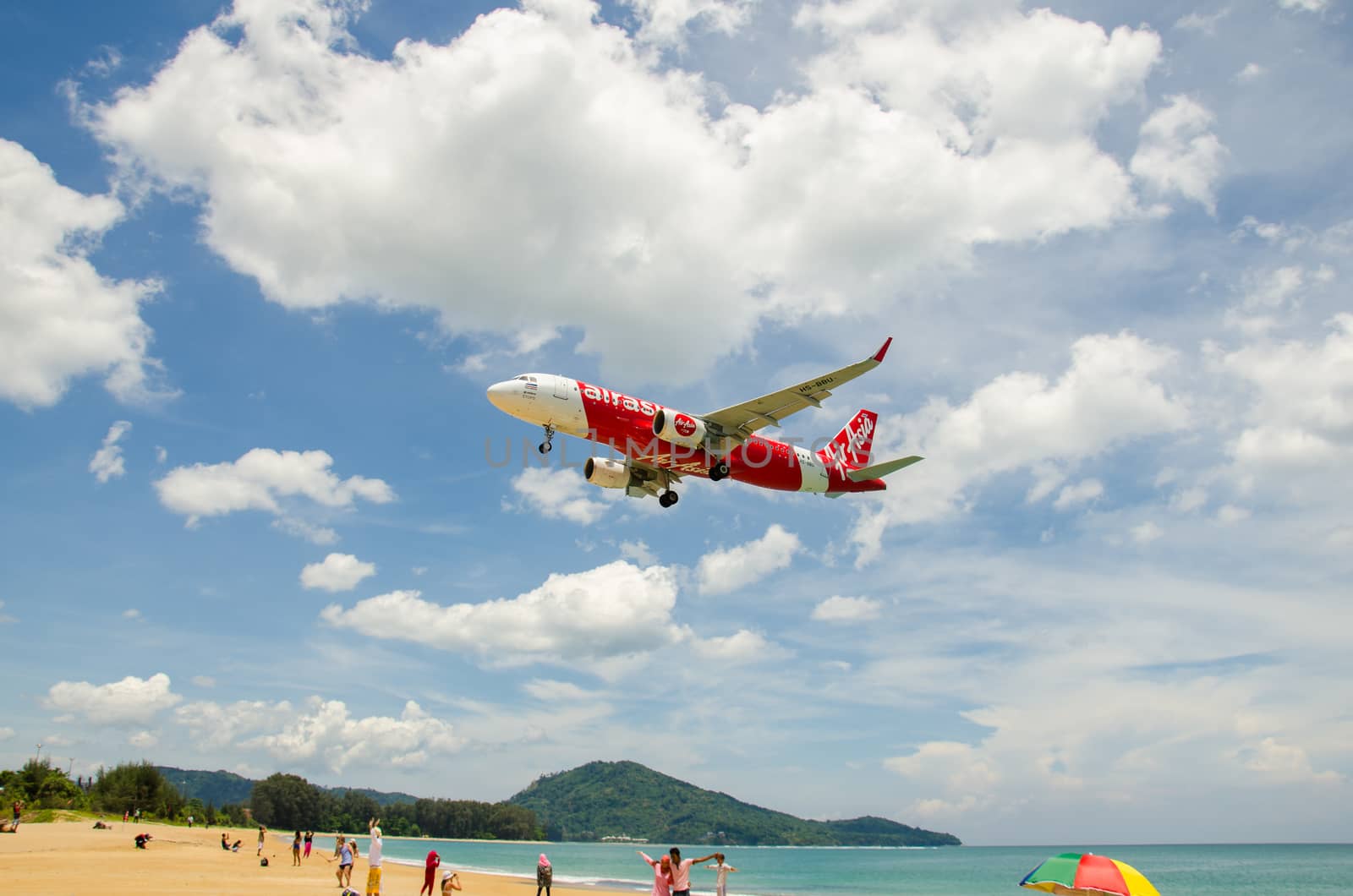 PHUKET - MAY 5 : Air Asia airplane landing at Phuket International airport, runway near the beach, on May 5, 2016 Phuket, Thailand.