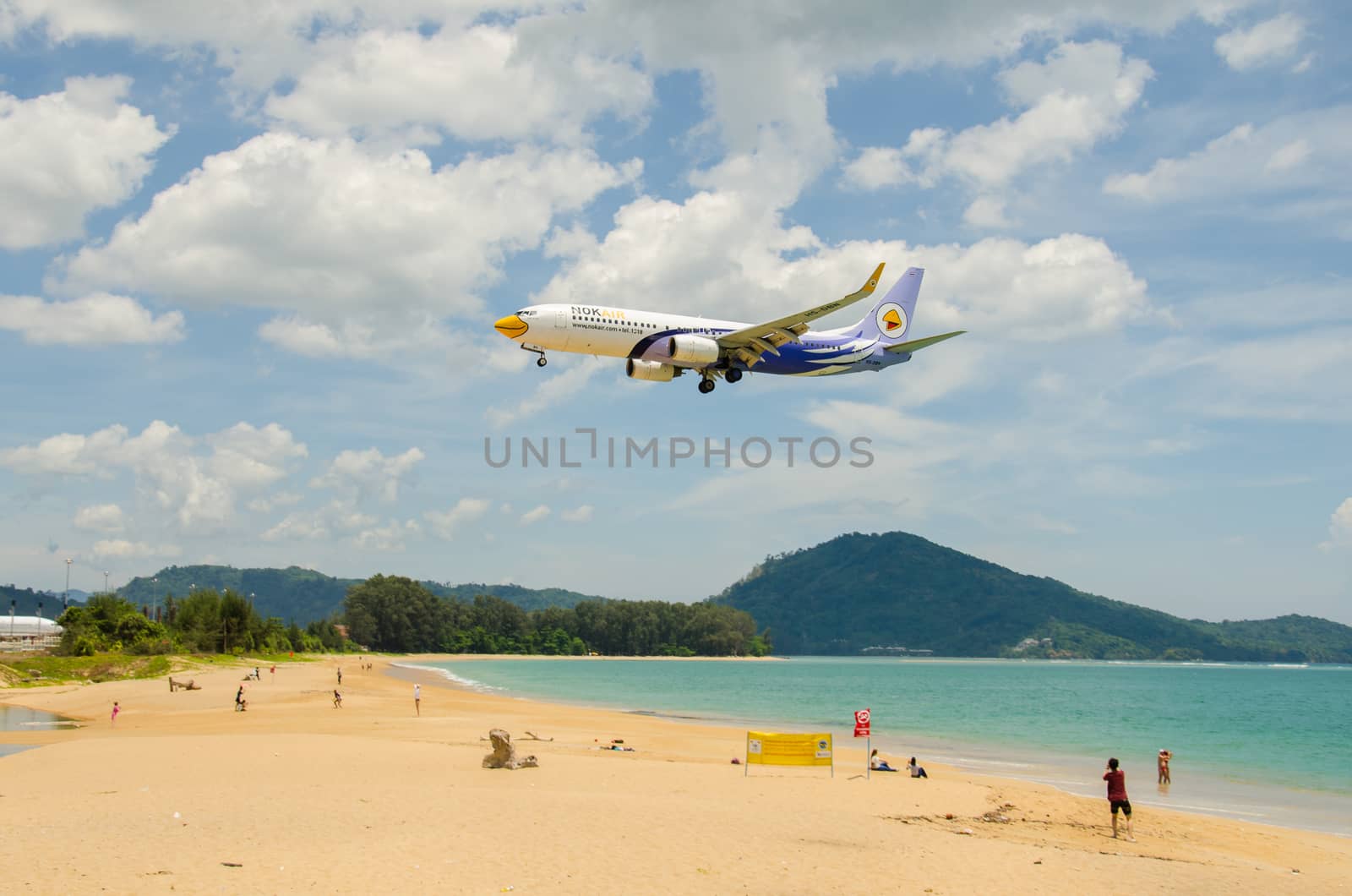 PHUKET - MAY 5 : Nok Air airplane landing at Phuket International airport, runway near the beach, on May 5, 2016 Phuket, Thailand.