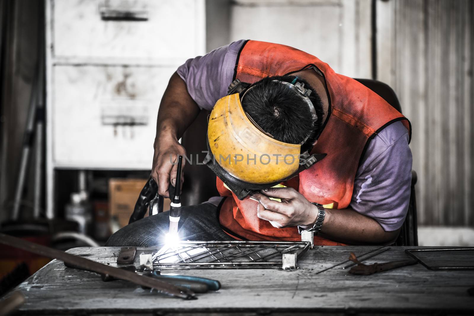 HDR image of a technician using tig welder in factory's workshop by beer5020