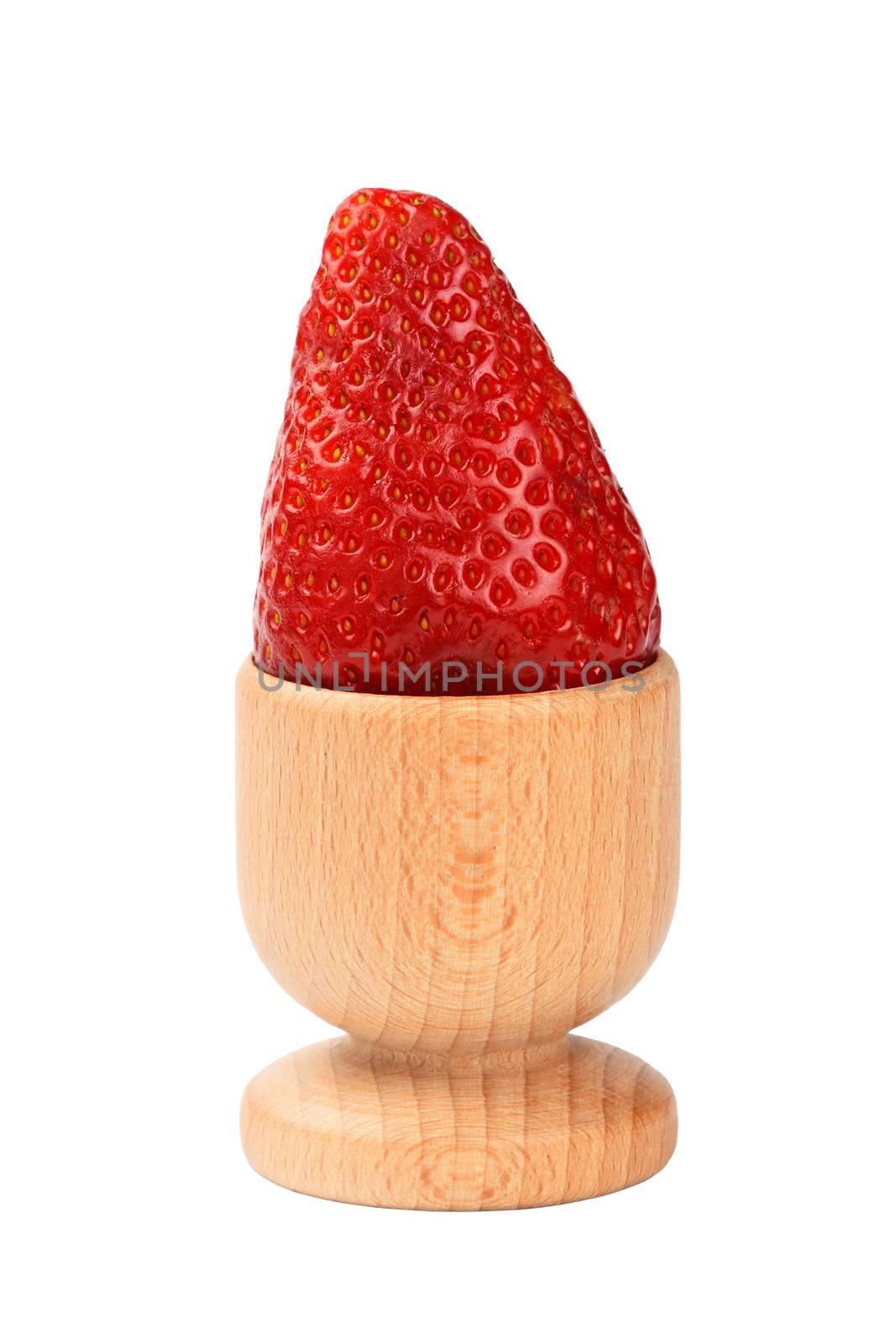 One big red mellow strawberry in wooden eggcup holder isolated on white background