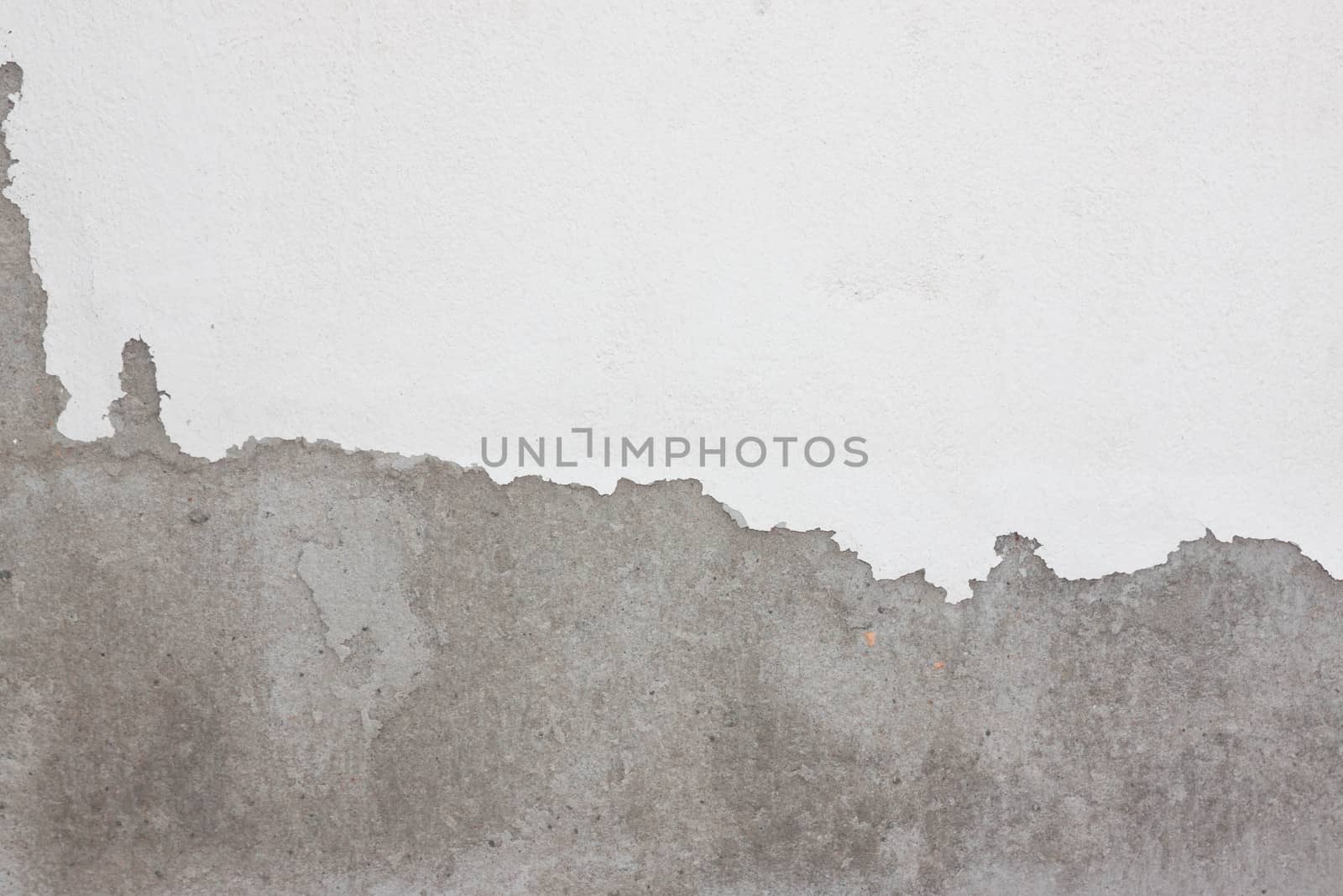 Grungy cracked white wall paint peeling off