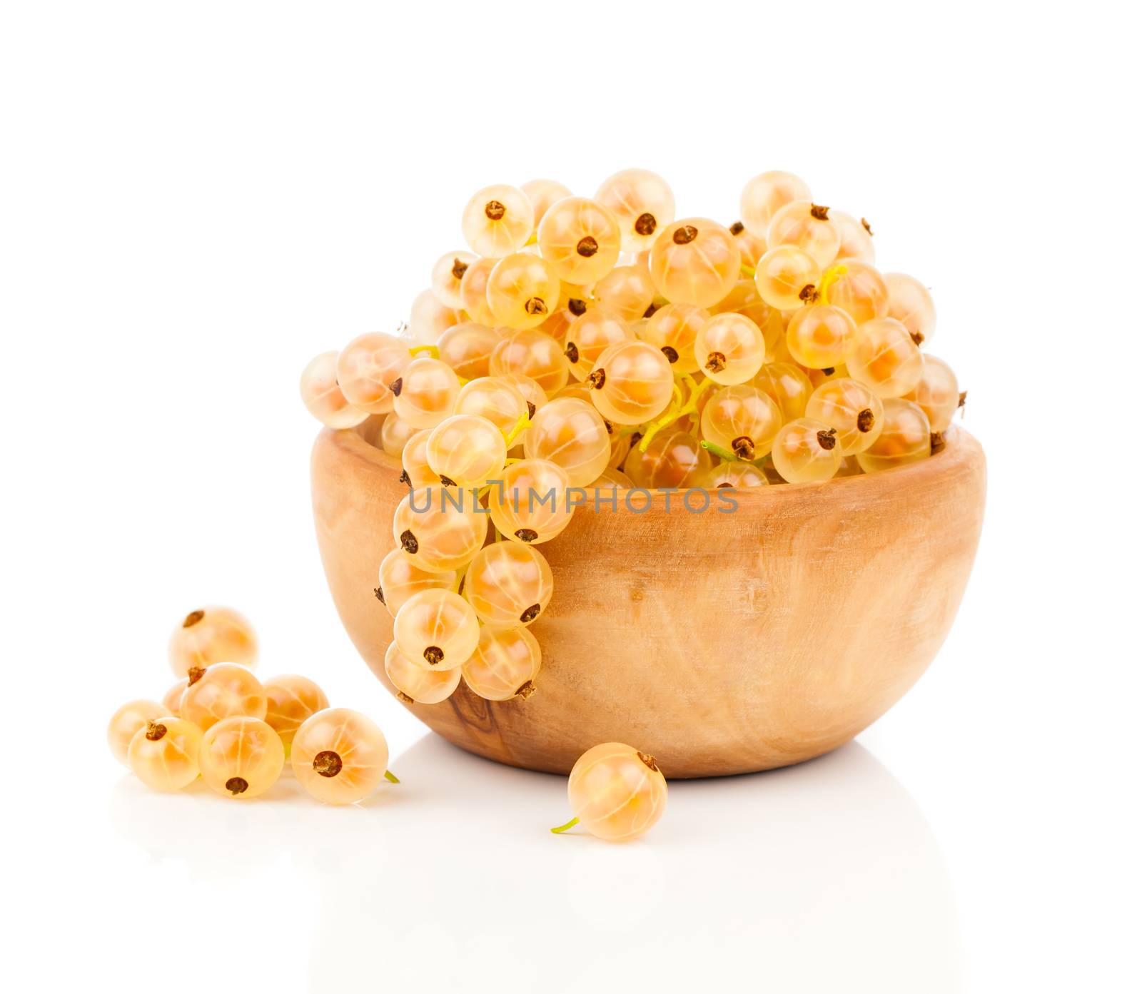 White currant fruit in a wood bowl, isolated over white backgrou by motorolka