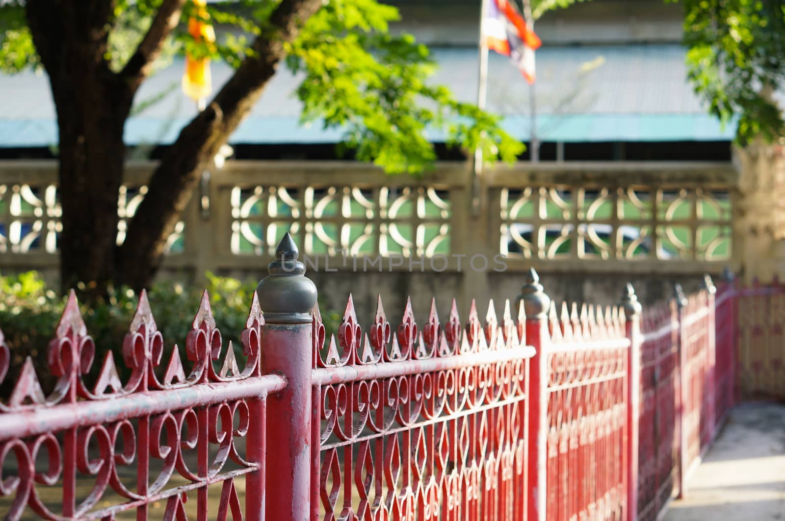 Red metal fence with sunlight  to feel warm  and safety.