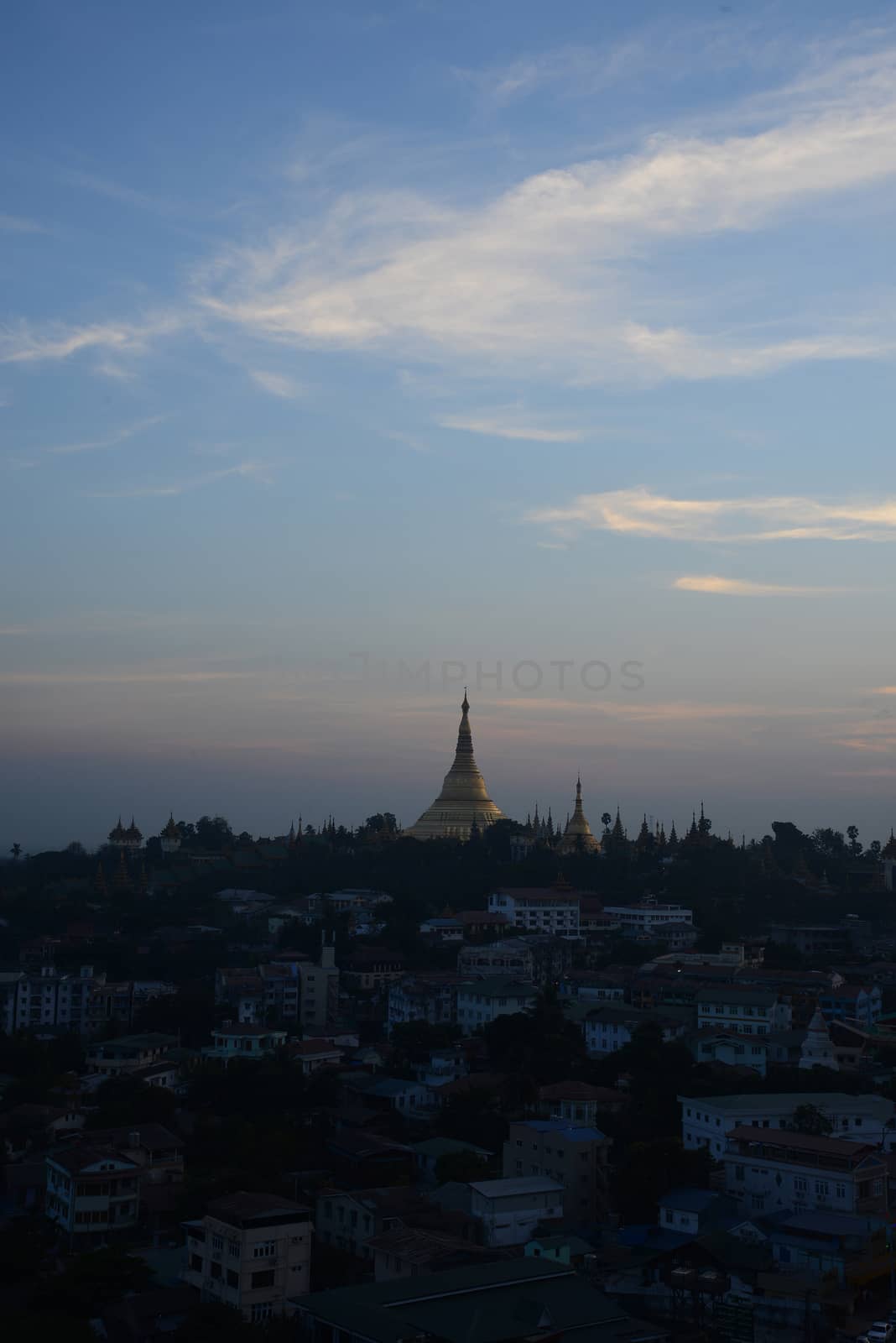 shwedagon pagoda surrounded by houses in yangon