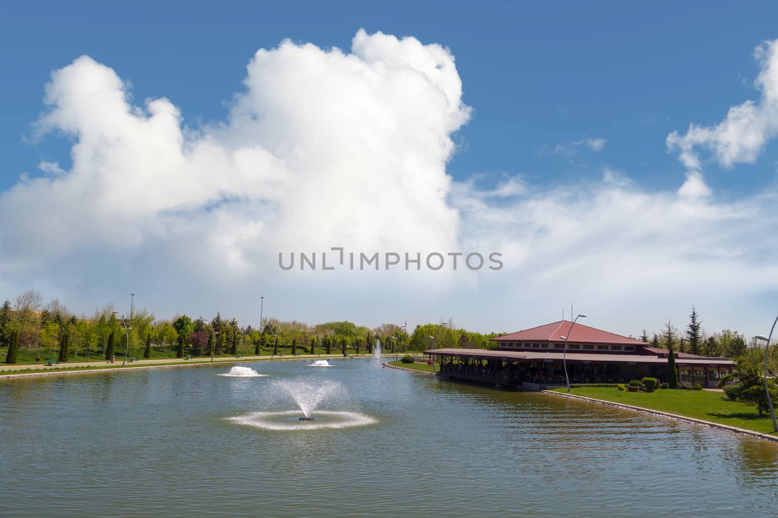 Landscape view of small lake around trees in Kentpark natural park in Eskisehir on blue sky background.