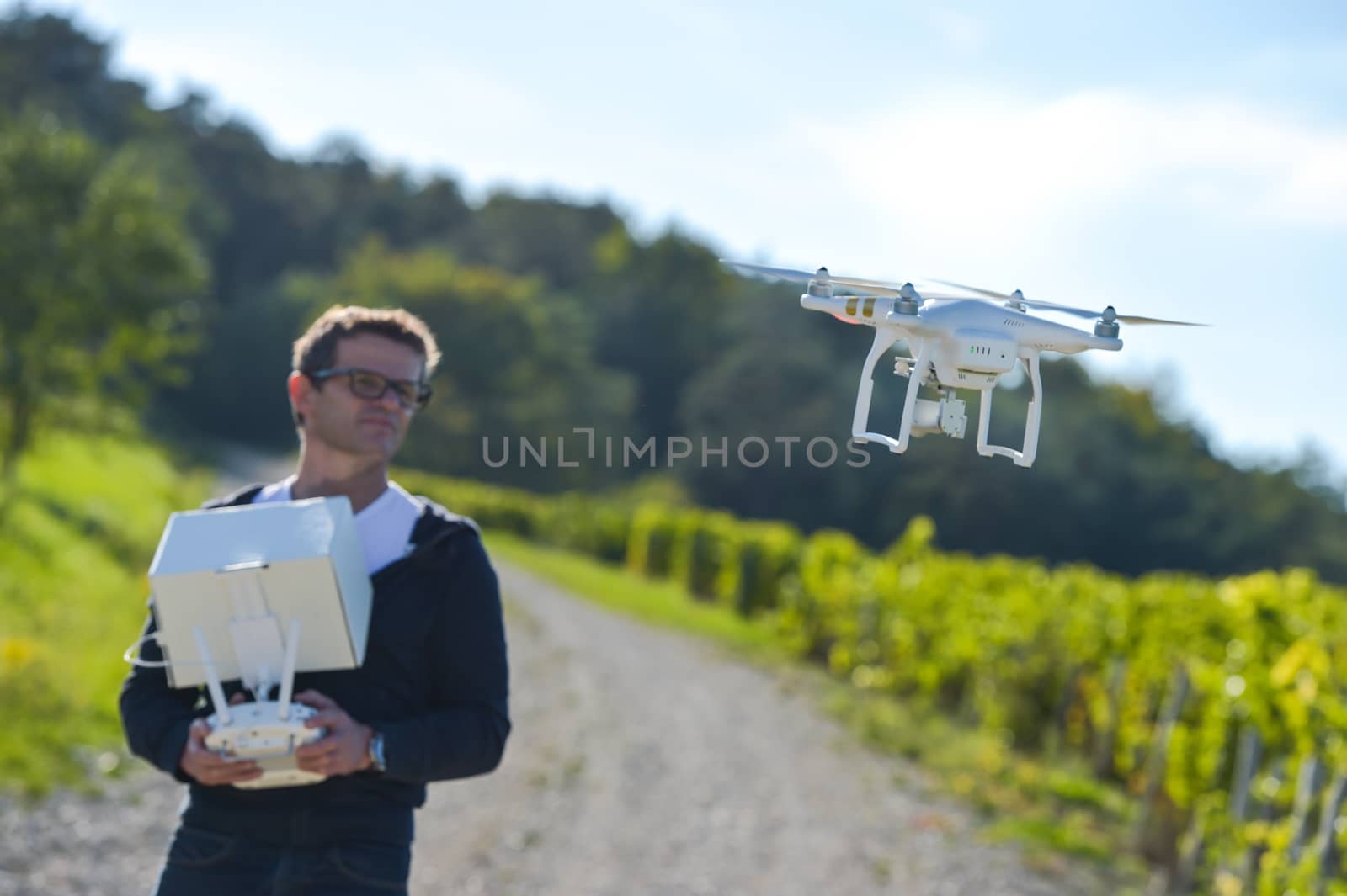 Man flying drone in wineyard, Champagne, France