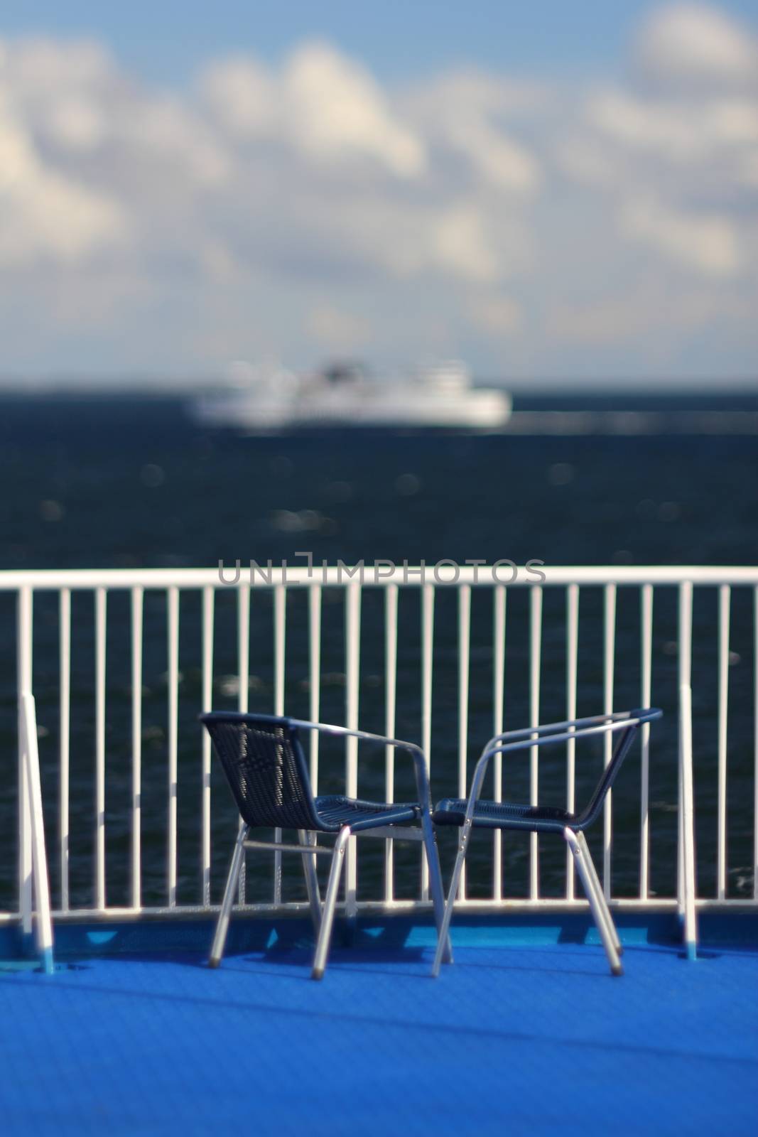 view over the railing of a ship, sea und other ship in the background