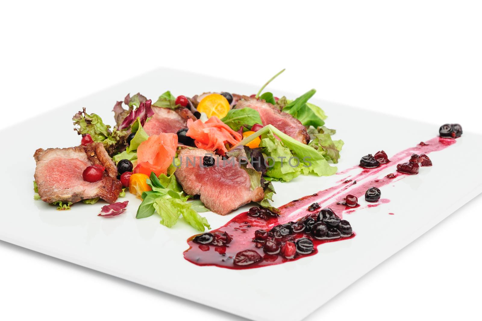 Grilled veal, pork or beef meat with cranberry and blackcurrant sauce, ginger and fresh vegetable salad