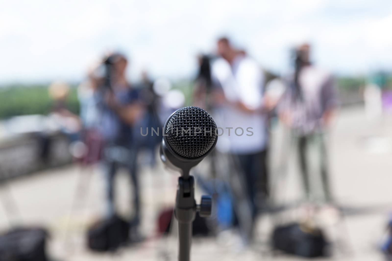 Microphone in focus against blurred background. Press conference.