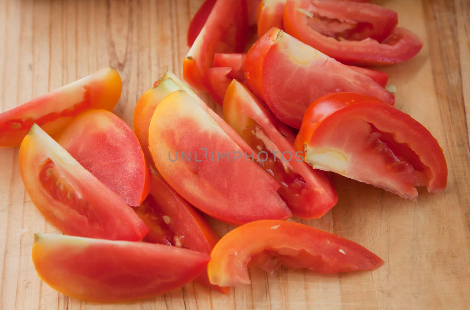 Sliced ​​tomato paste on a wooden cutting board.
