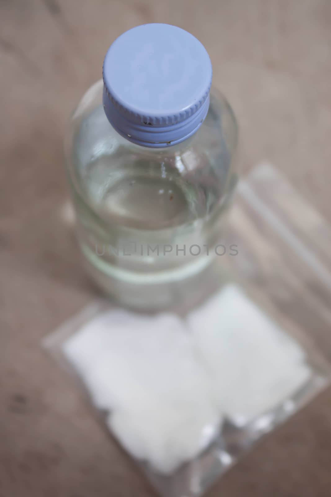 Alcohol bottles of white and wool used to clean the wound.