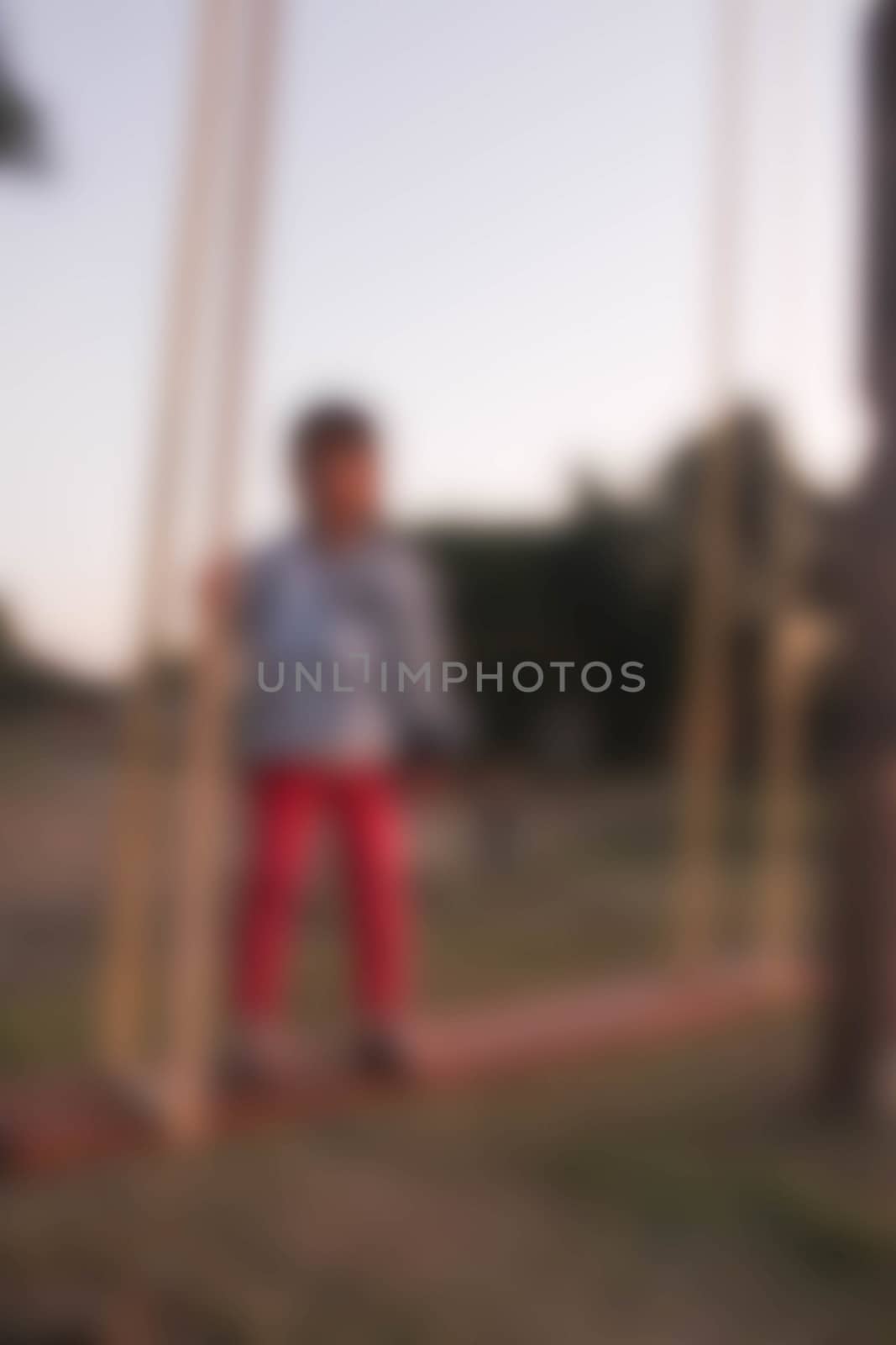Small child on a swing on a walk