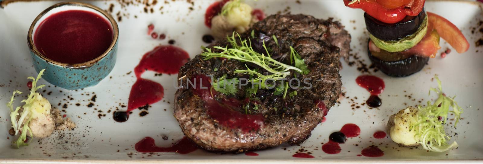 grilled beef steak with herbs vegetables and sauce