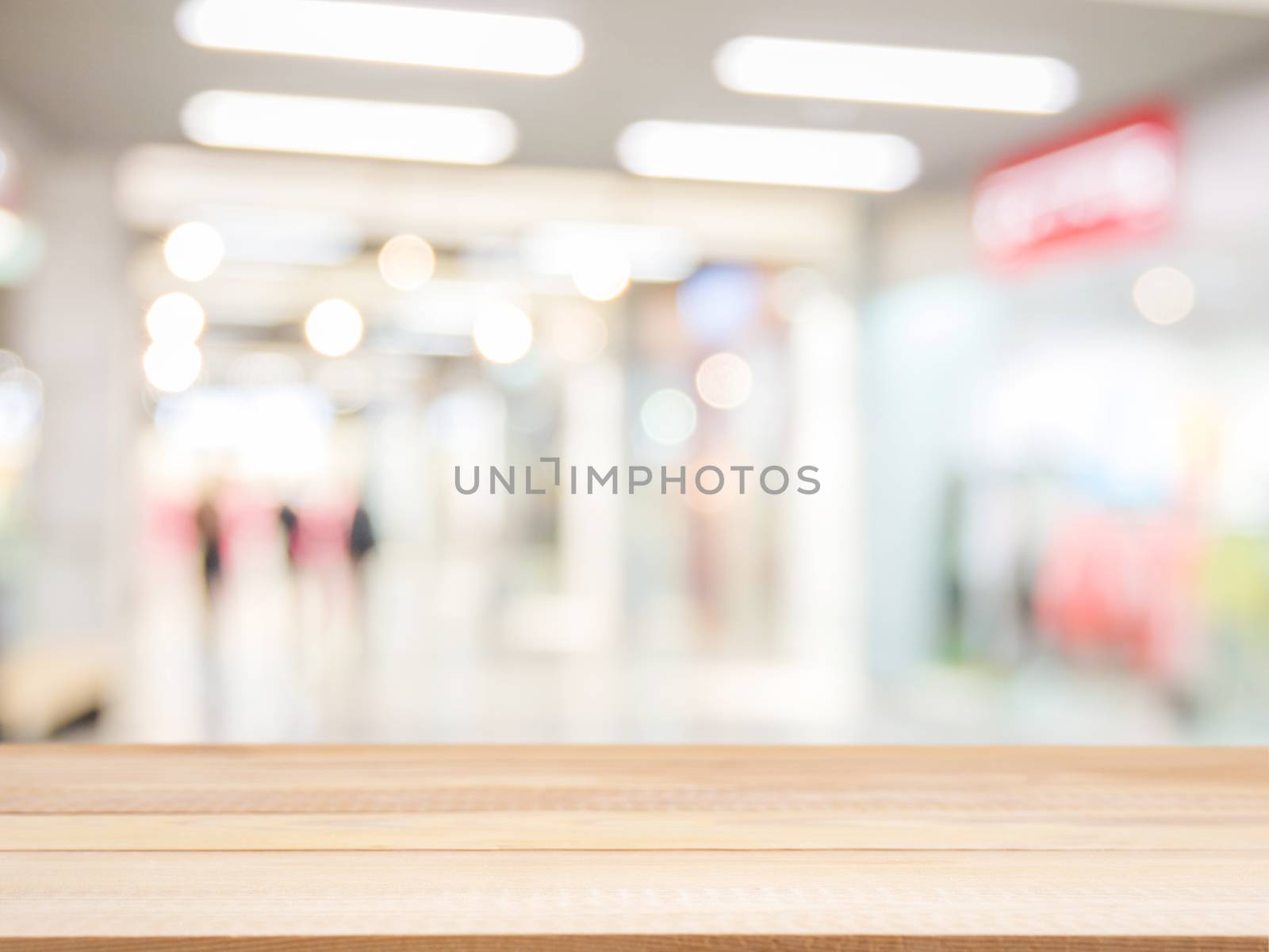 Wooden board empty table in front of blurred background. Perspective light wood over blur in shopping mall - can be used for display or montage your products. Mock up for display of product.