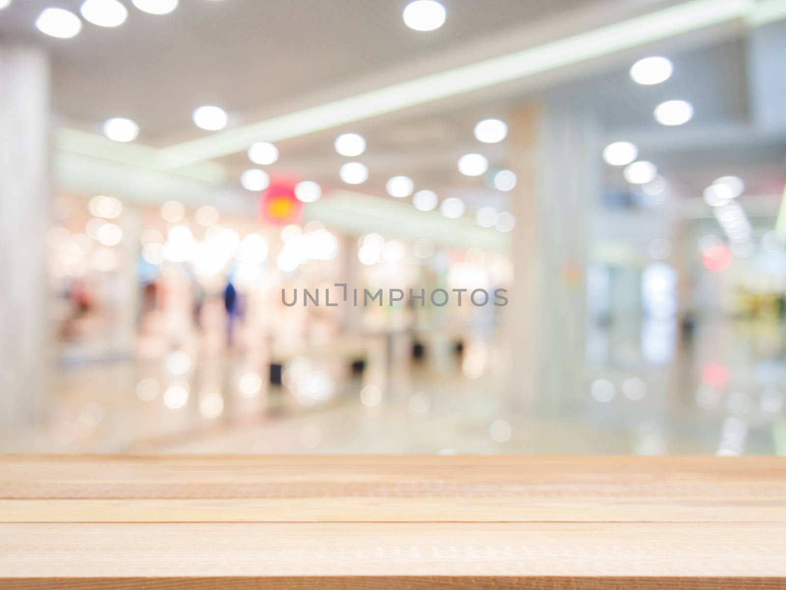 Wooden board empty table in front of blurred background. Perspective light wood over blur in shopping mall - can be used for display or montage your products. Mock up for display of product.