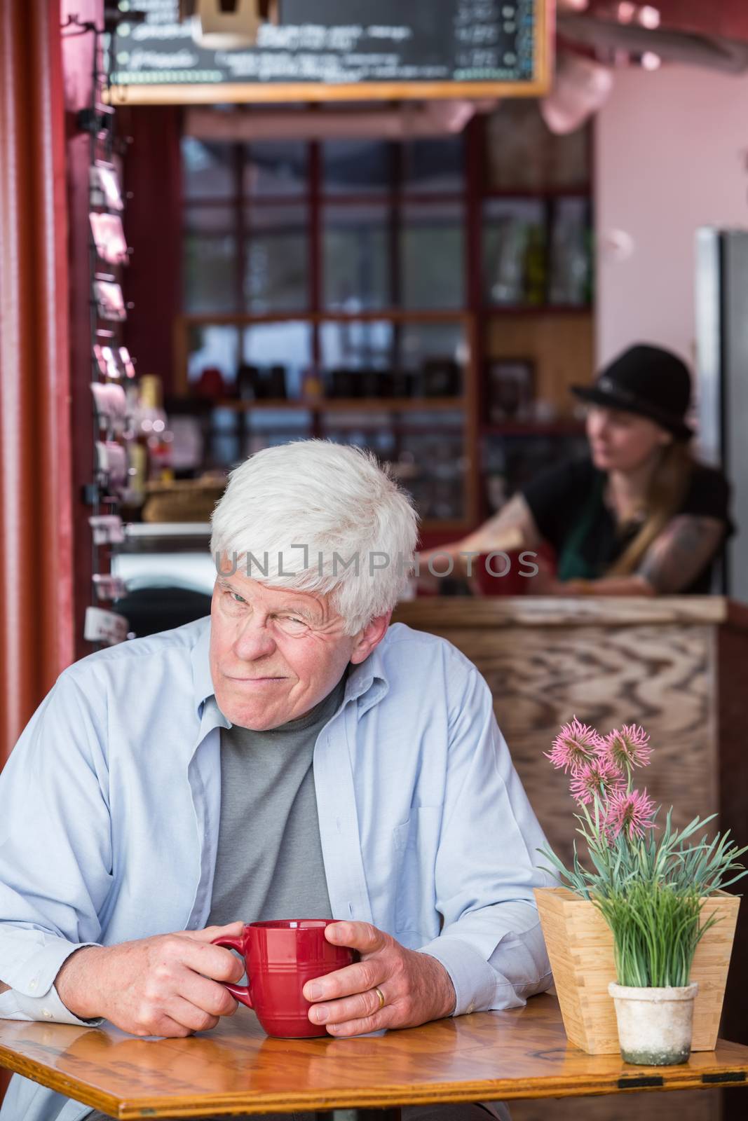 Grumpy Mature Man in Coffee House by Creatista
