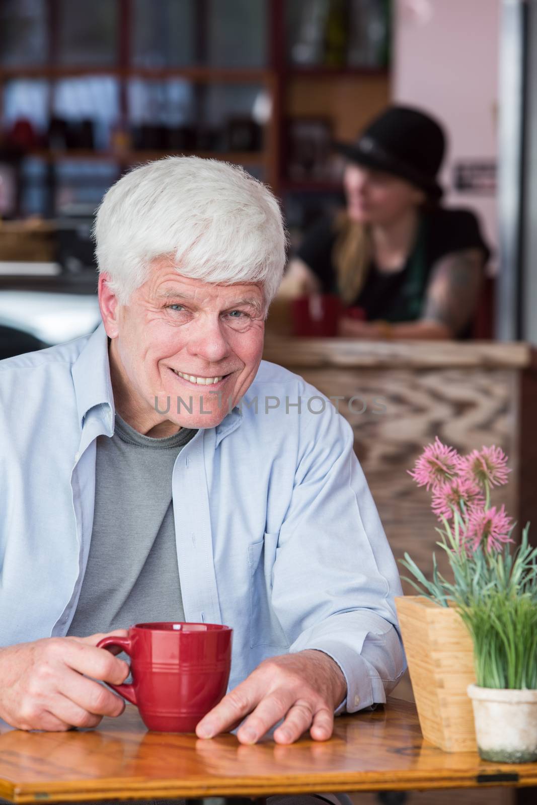 Happy Mature Man in a Bistro by Creatista