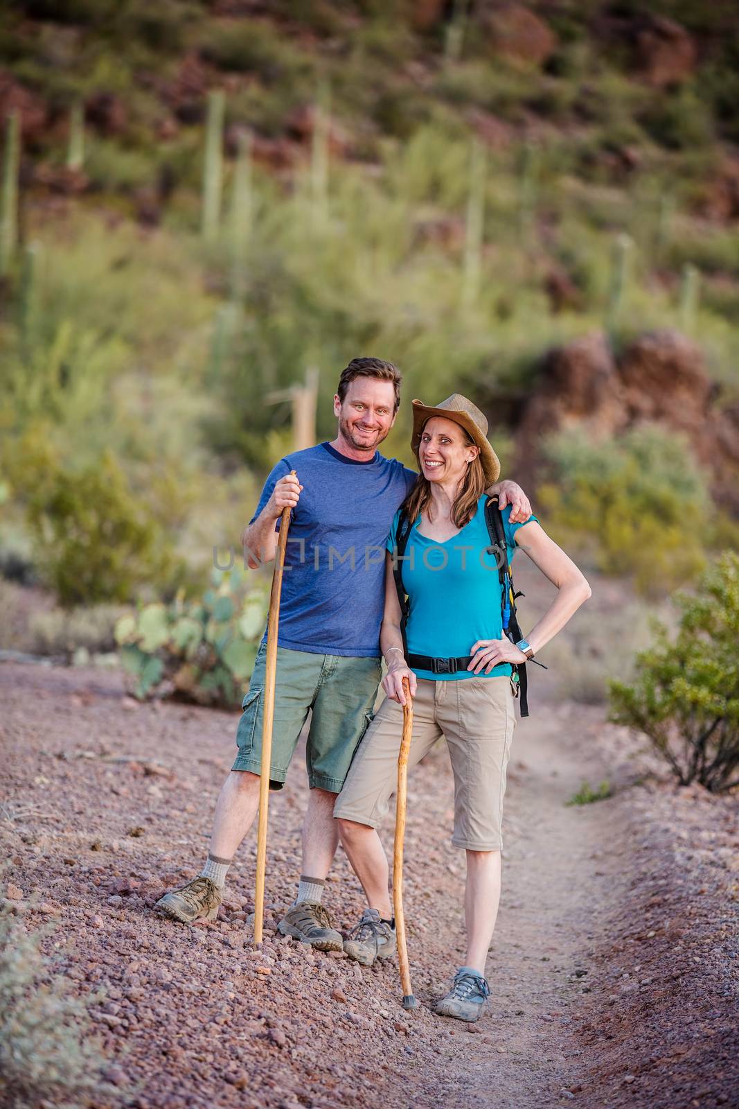Affectionate couple hiking nature trail in the American Southwest
